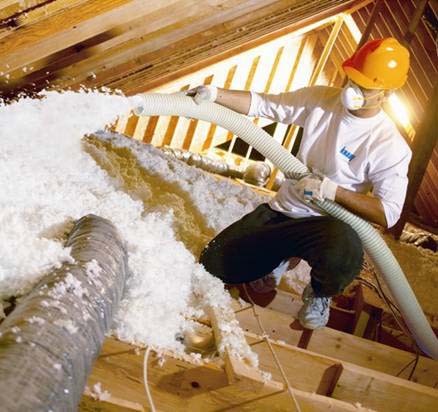 Man installing blow in insulation