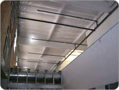 Metal roof for a building with black beams across for support 
