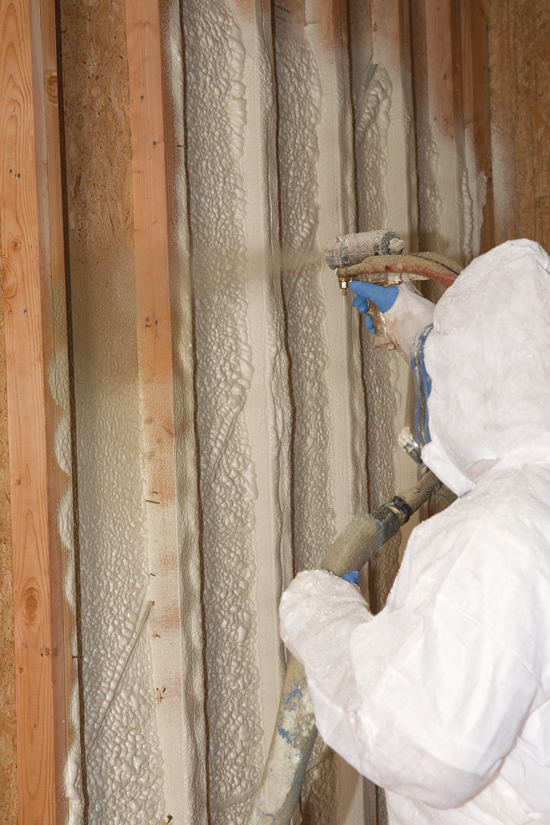 Insulation contractor installing spray foam